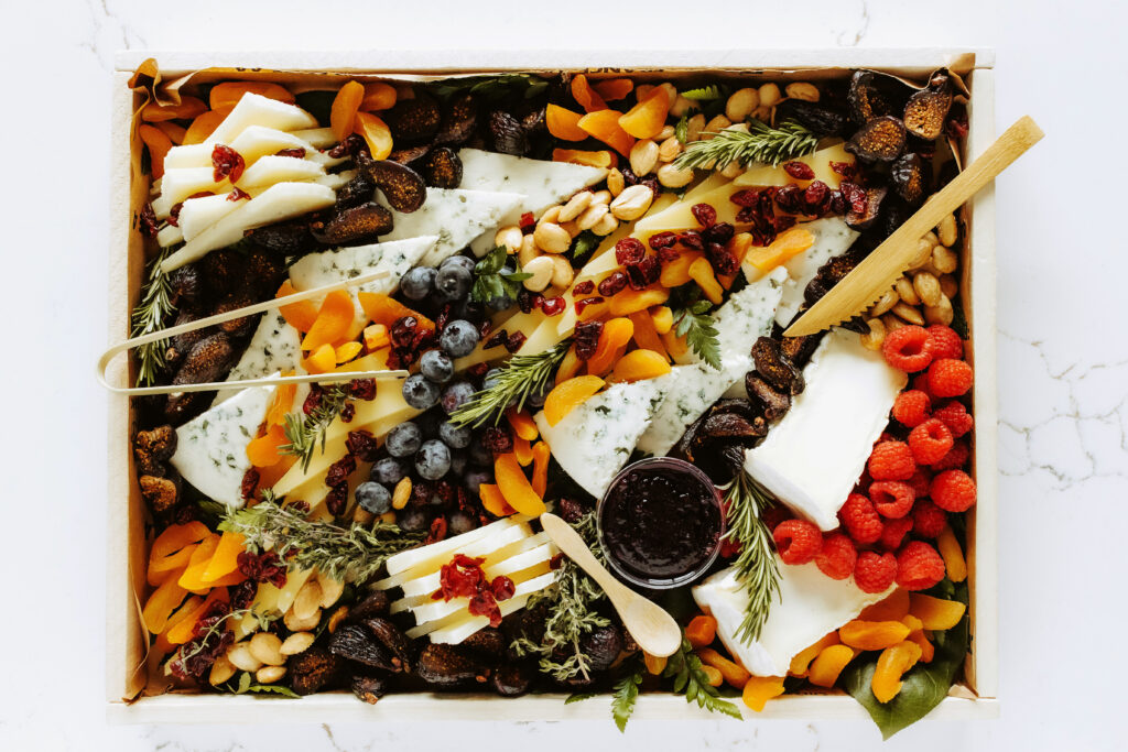 Beautiful board filled with charcuterie, cheese, fruit, and nuts